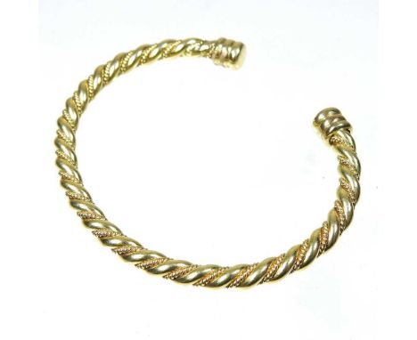 An 18 carat gold bangle, of ropetwist design, 29g, 7cm wide