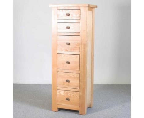 A modern light oak narrow chest of six drawers47w x 40d x 128h cm