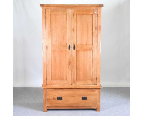 A modern light oak wardrobe, with a drawer below109w x 58d x 193h cm