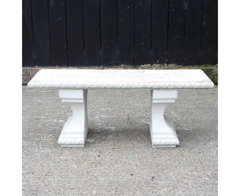 A reconstituted stone garden bench, on shaped supports105w x 36d x 41h cm