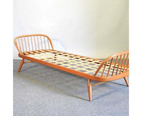 A 1970's Ercol light elm day bed frame, on a splayed base, 207cm wide