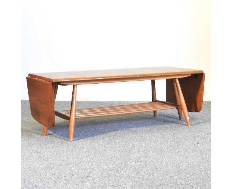 A 1970's Ercol light elm drop leaf coffee table, on a splayed base, 104cm wideOverall complete and usable. Extends as it shou