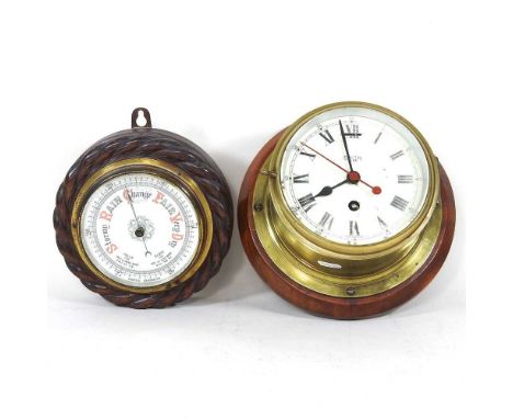 A Smith Astral brass cased ship's clock, 24cm diameter, together with an early 20th century oak cased aneroid barometer, with