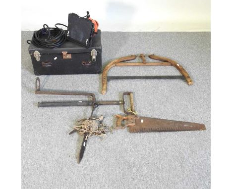 A collection of hand tools, to include a bow saw