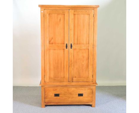 A modern light oak double wardrobe, with a drawer below109w x 58d x 193h cm