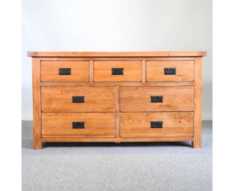 A modern light oak chest, containing an arrangement of seven short drawers138w x 42d x 77h cm 