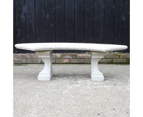 A cast stone garden bench, of curved design, 130cm wide