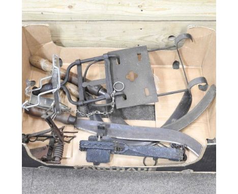 A collection of various animal traps and tools