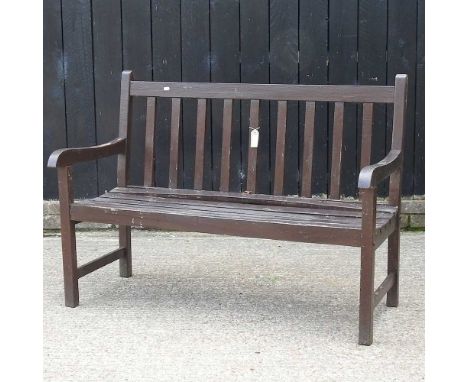 A brown painted garden bench, 122cm wide