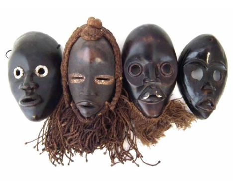 Four Dan masks the largest measures 25.5cm high     All lots in this Tribal and African Art Sale are sold subject to V.A.T. T