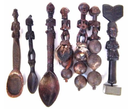 Three spoons, a wand and three rattles, carved in the Yoruba, Songye, Luba and Hemba styles, 35cm max height       All lots i