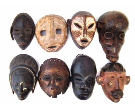 Eight African masks carved in various tribal styles, the largest measures 31cm high    All lots in this Tribal and African Ar