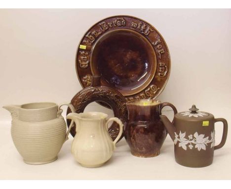 Mid 19th century brown Majolica bread dish, a ring shpae decanter, also three jugs and a tea pot. Condition report: see terms