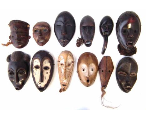 Twelve African passport masks carved in various tribal styles, the largest measures 19cm high      All lots in this Tribal an