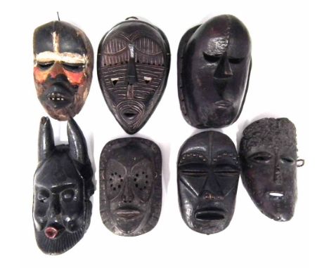 Seven African masks carved in various tribal styles, the largest measures 29cm high    All lots in this Tribal and African Ar