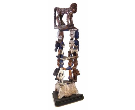 Urhobo dance crest, carved with three layers of painted figures topped by a leopard, 96cm high     All lots in this Tribal an