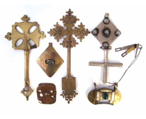 Two Ethiopian metal Coptic Hand Crosses, a pendant cross and three other pendants, (6) the largest measures 26cm high     All