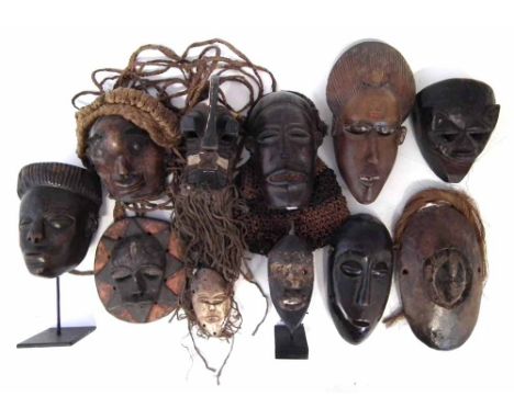 Eleven African masks carved in various tribal styles, the largest measures 22cm high    All lots in this Tribal and African A