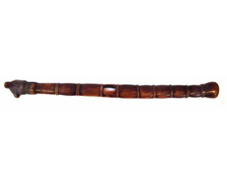 Animal bone staff or club, with ribbed body, carved with animal head capital, 71cm long    All lots in this Tribal and Africa