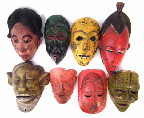 Eight painted African masks carved in various tribal styles, the largest measures 37cm high    All lots in this Tribal and Af