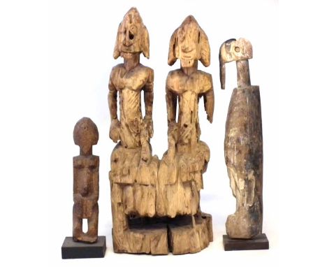 Dogon couple carved playing a balafon, together with two other figures, the couple measure 35cm high    All lots in this Trib