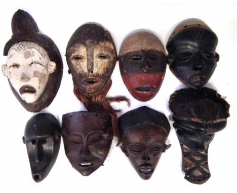 Eight African masks carved in various tribal styles, the largest measures 35cm high    All lots in this Tribal and African Ar