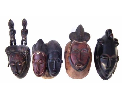 Baule mask carved with two figures and three other masks, 39cm high     All lots in this Tribal and African Art Sale are sold