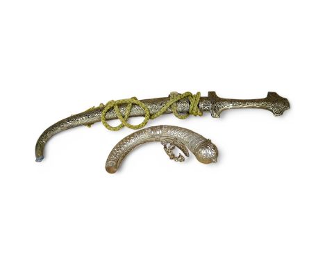 An Omani silver spice box in the form of a curved powder flask, together with a Moroccan dagger Jambiya with nickel hilt and 