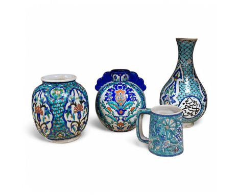 Two Persian vases and a mug, decorated with stylised flowers together with a Laroche Belgium Persian style vase, tallest 28.5