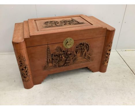 A Chinese carved camphor wood trunk, width 102cm, depth 54cm, height 60cm. Condition - poor, sun faded