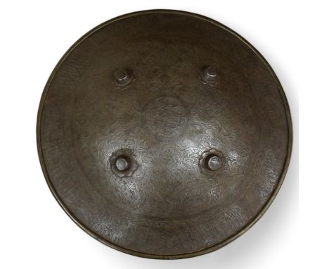 An early 20th century Persian steel shield dhal, 47cm diameter, with pairs of seated figures, brass reinforced brim, four cen