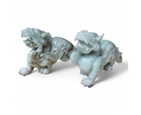 A pair of carved Chinese bowenite jade dragons, 28cm wide. Condition - fair