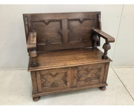 A 1920's oak monk's bench, width 107cm, depth 48cm, height 100cm. Condition - fair