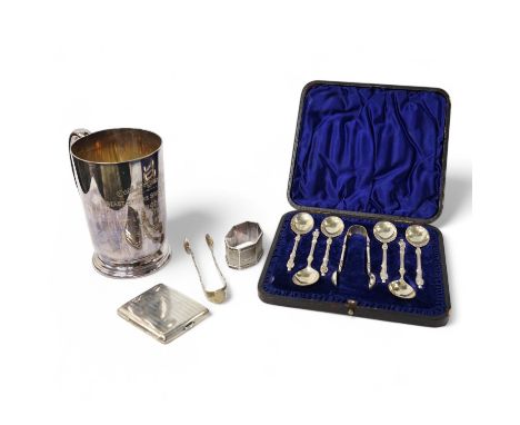 A George V silver mounted brass cased travelling timepiece, London, 1916, 70mm, together with a silver napkin ring, a pair of