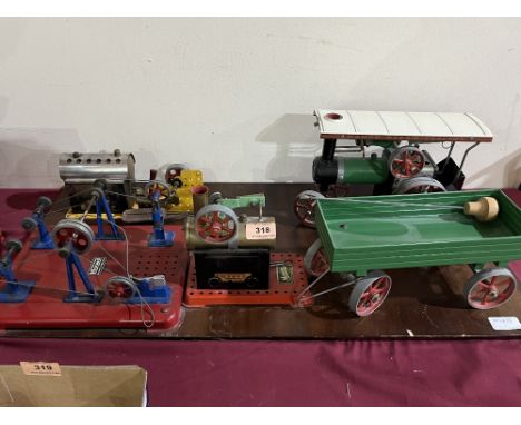 A Mamod TEIA traction engine and trailer; two live steam stationary engines and accessories mounted on a wood board.