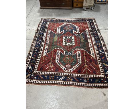 An eastern red ground carpet. 98" x 76".