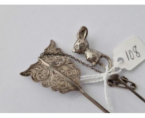 A White Metal Mouse Toped Stick Pin Together With A Silver Arrow Brooch