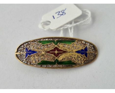 A Filigree And Enamel White Metal Oval Brooch