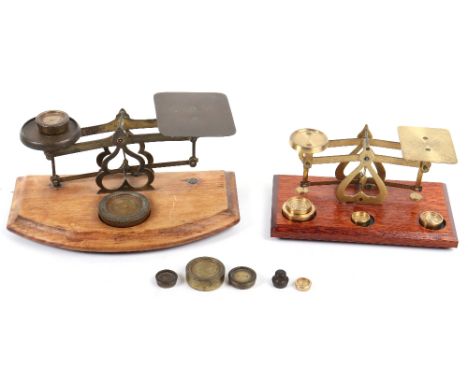 A set of late 19th century brass postal scales, with a later set, each with brass weights