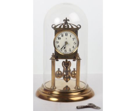 An early 20th century German anniversary clock, by Badische Uhrenfabrik, enamel dial with Arabic numerals, with glass dome, a