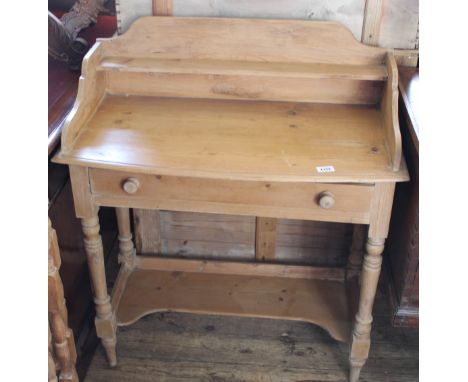 A Victorian pine washstand with shaped upstand and lower shelf