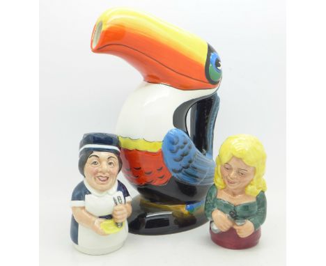 A Guinness toucan ceramic jug and two Royal Doulton candle snuffers
