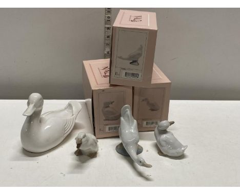 Three Nao figurines with boxes and one larger Poole pottery duck, shipping unavailable