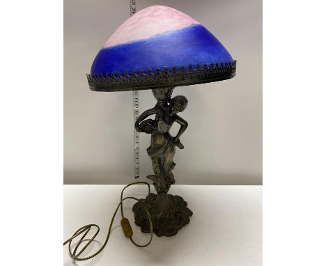 A cast metal lamp base in the style classical figure with a pink and blue swirl glass shade h63cm, shipping unavailable