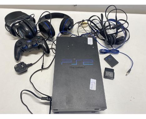 A PlayStation 2 console with accessories (powers up) 
