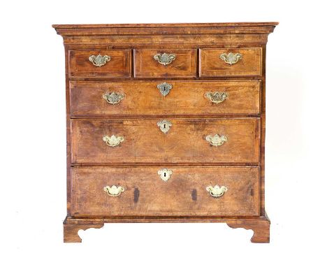 A George I Walnut and Feather-Banded Straight Front Chest, the later oak top above three short and three oak-lined long drawe