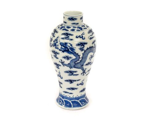 A Chinese Porcelain Baluster Vase, Kangxi reign mark but not of the period, painted in underglaze blue with dragons chasing t