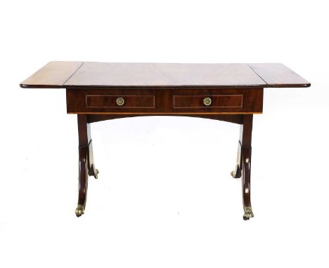 A Regency Mahogany and Boxwood-Strung Sofa Table, early 19th century, with two rounded drop leaves above four frieze drawers,