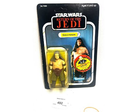 Kenner Star Wars vintage Return of the Jedi Rancor Keeper 3 3/4" figure, Mint, within Excellent (yellowed) bubble, upon Excel