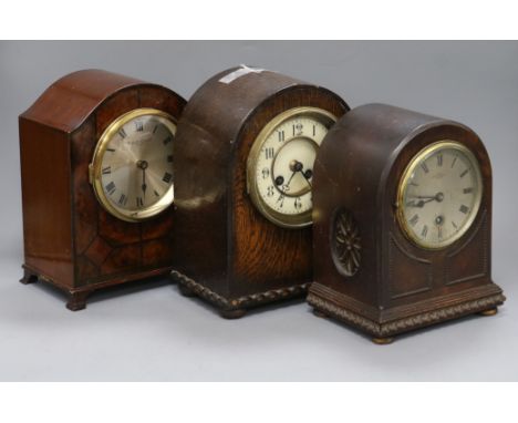 A French burr walnut mantel clock, a French oak mantel clock and an English oak mantel clock